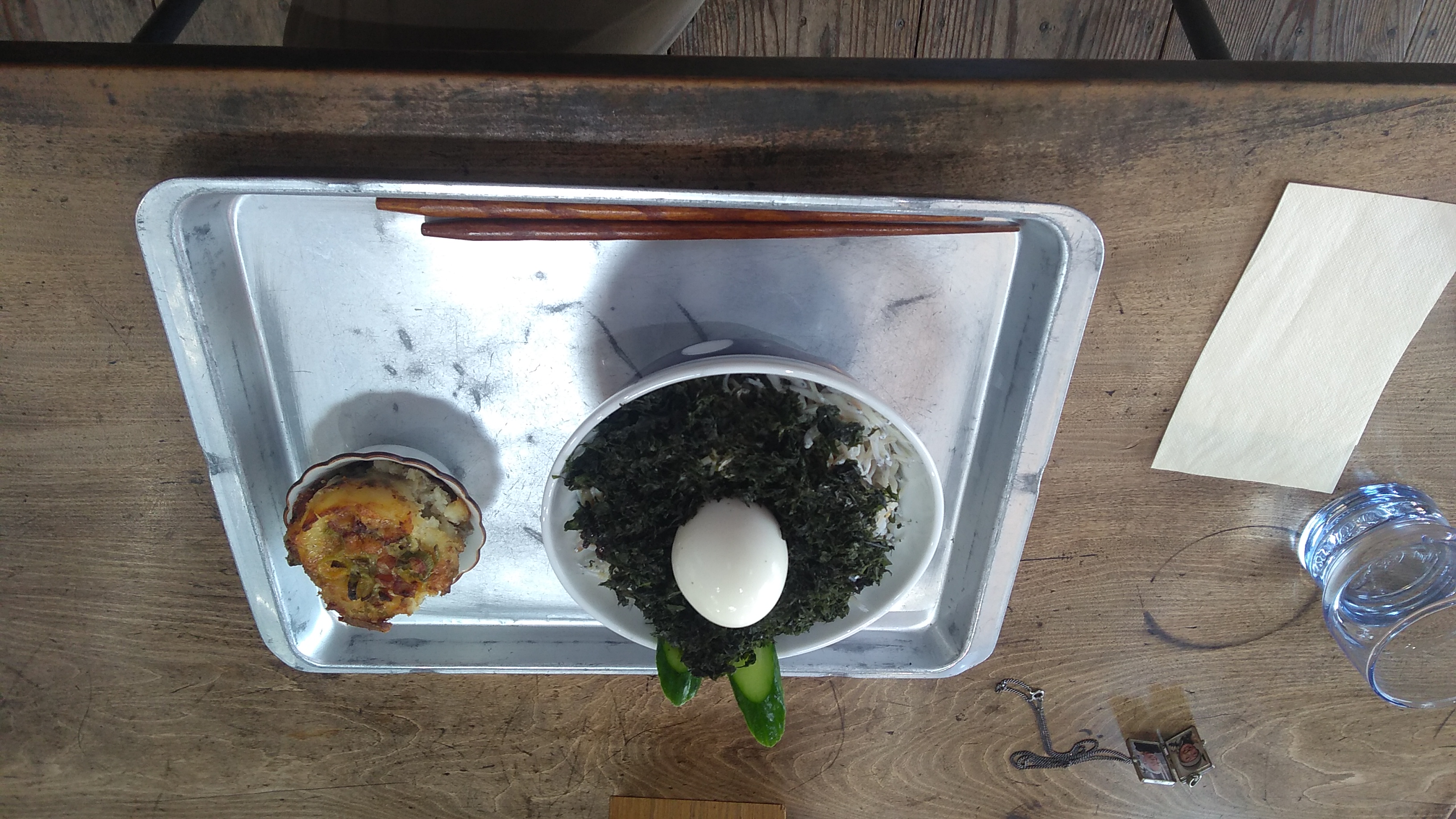 A rice bowl topped with shirasu (tiny “whitebait” fish), nori, and a boiled egg, with a small quiche on the side.